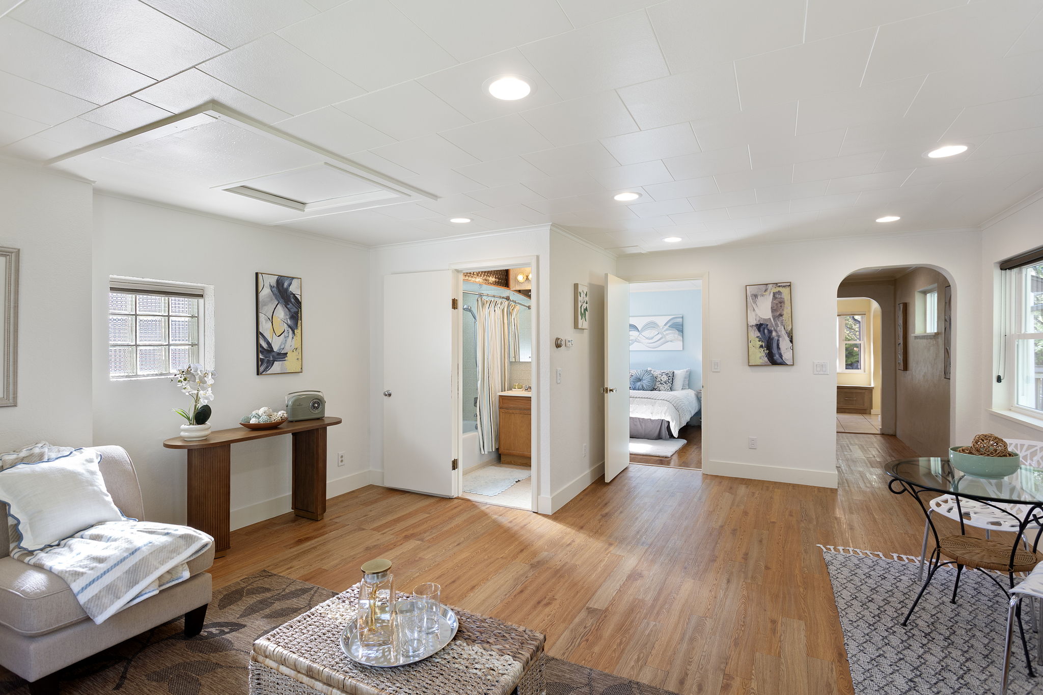 From the living area, an easy flow connects kitchen, bedroom, and bath—bright and practical, with room to breathe.
