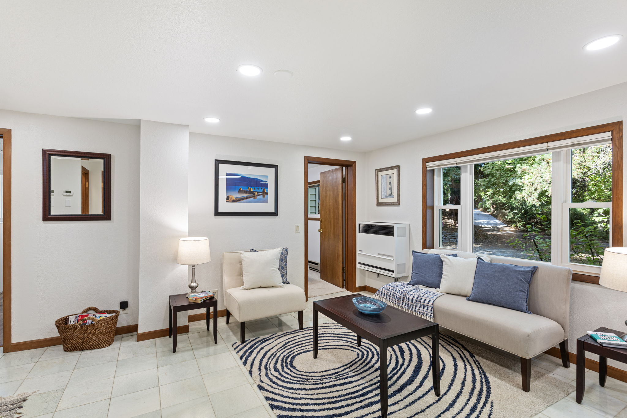 Tucked beneath the canopy, this space feels almost like a forest retreat. The large picture window connects you to the outside without sacrificing comfort inside.