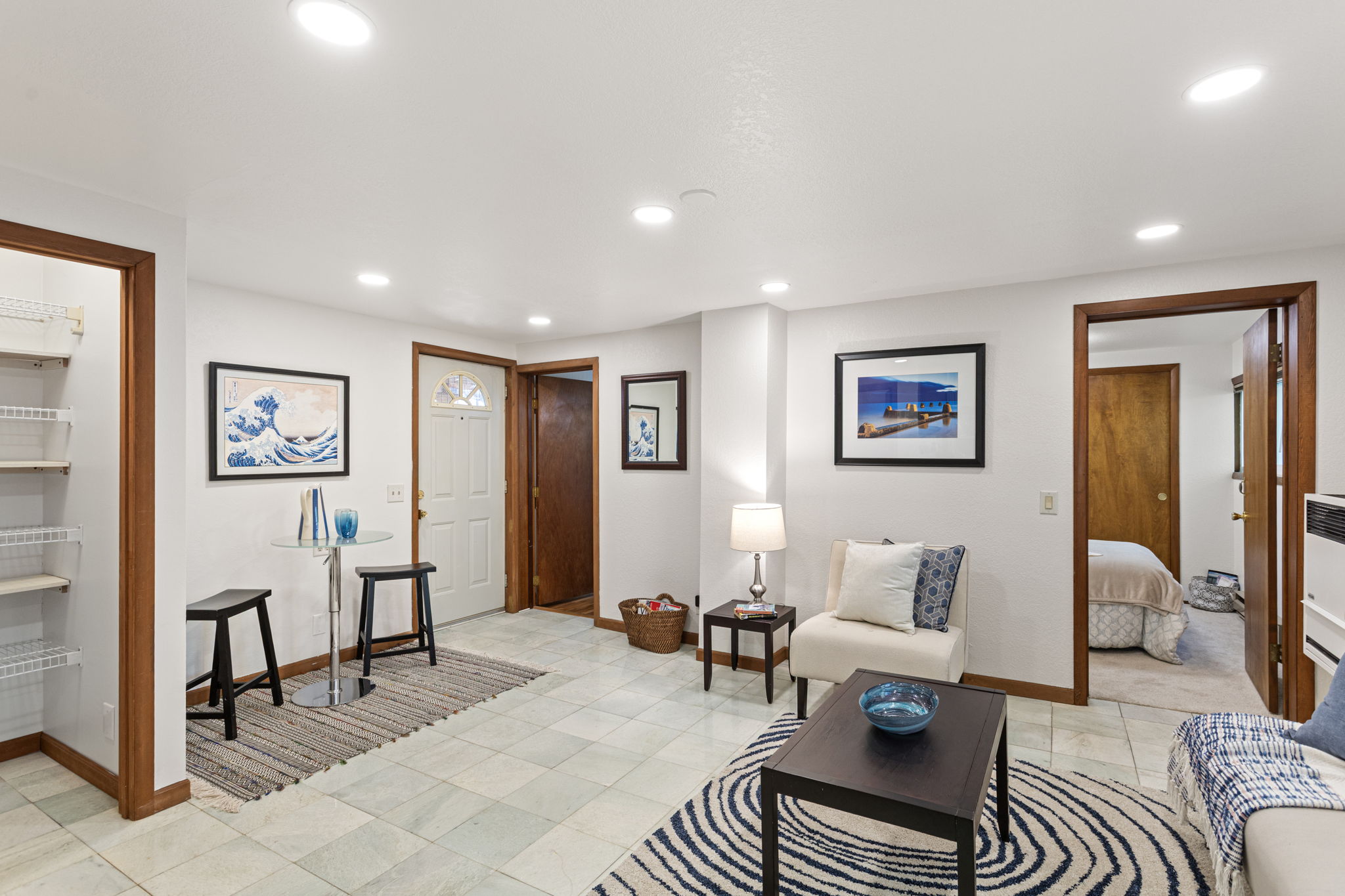 This entry nook adds charm and function, with room for a small dining table, storage shelves, and easy flow to the rest of the unit.