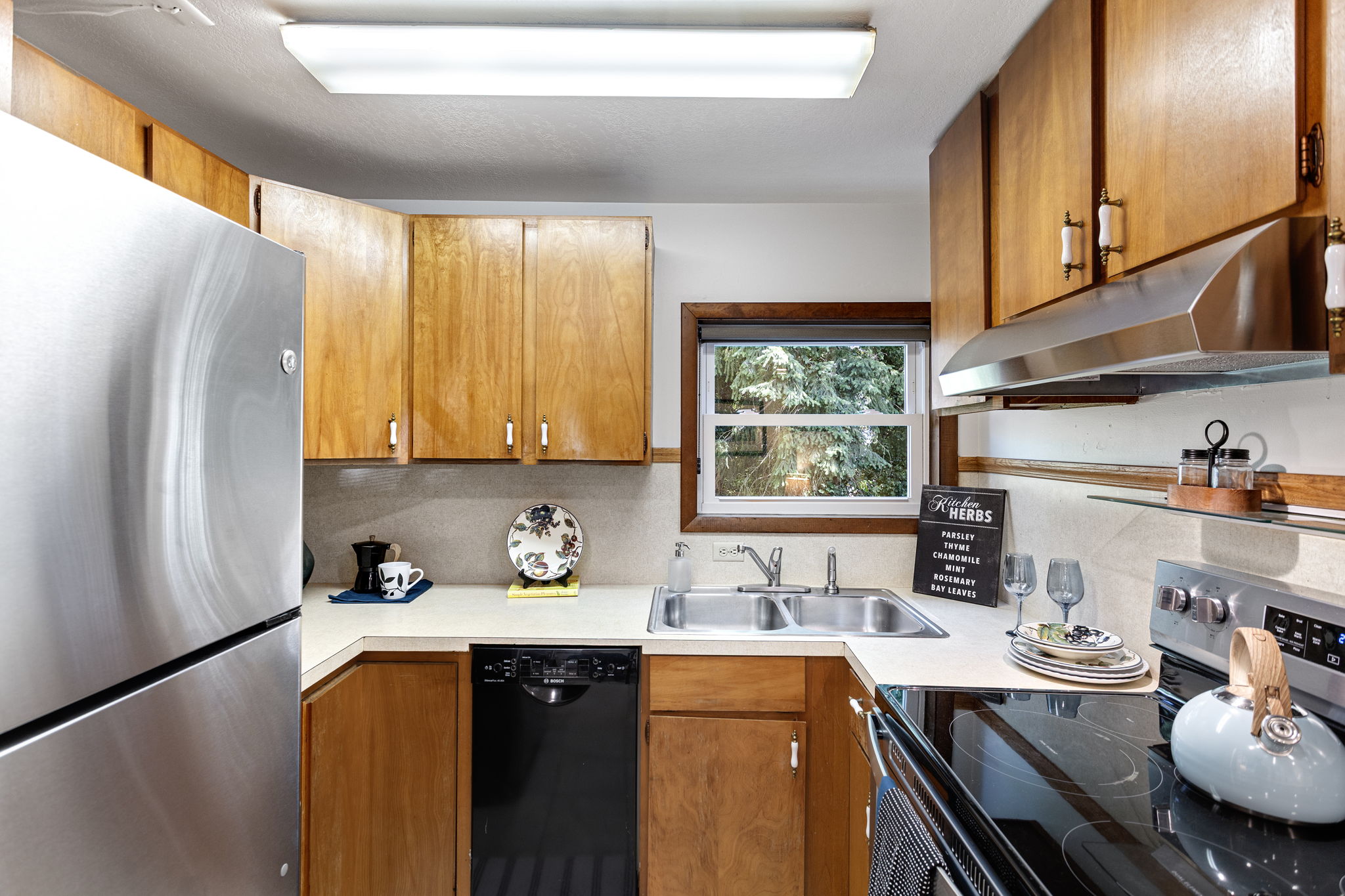 Framed by trees, the kitchen looks east for gentle morning light—ideal for a calm start to the day.