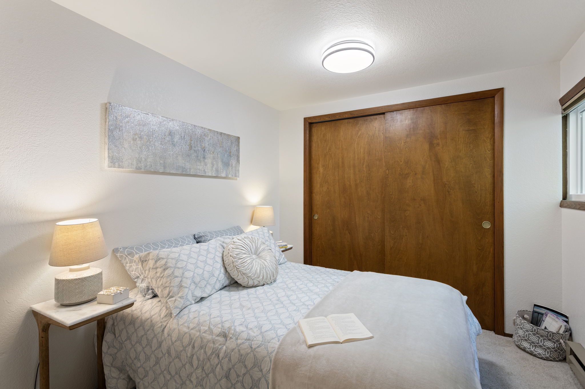 Just off the living room, this restful retreat enjoys gentle, consistent natural light and easy proximity to shared spaces.