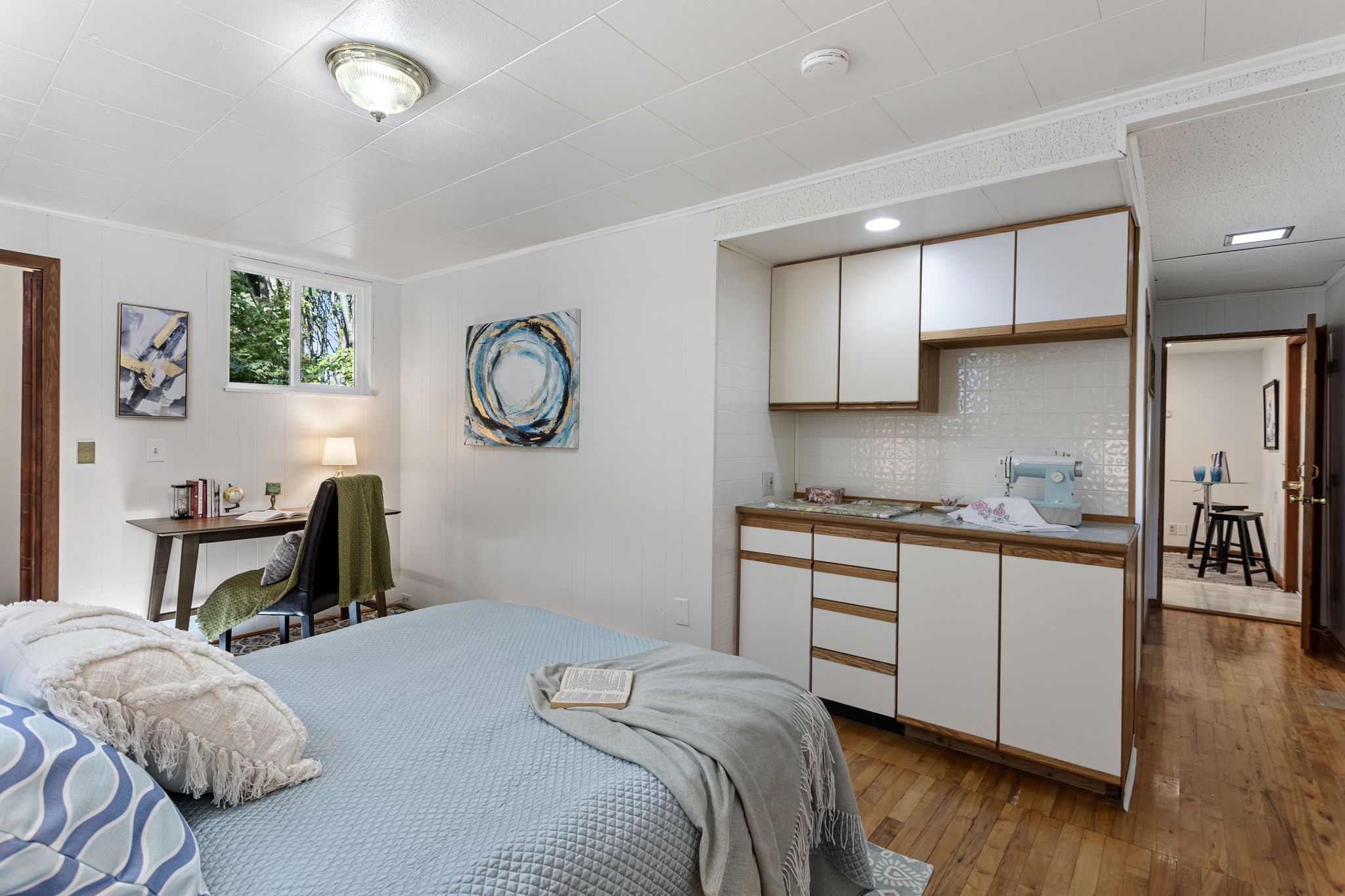A built-in flex zone with cabinetry adds utility and workspace—perfect for crafts, hobbies, or remote work—with views toward the adjacent greenery. Comfortable. Connected. Independent. This 2-bedroom lower level features wood floors, a spacious primary suite with walk-in closet, a second full bath, and a private entrance. It’s ideal as a main residence, a welcoming home for extended family or long-term guests, or a potential rental opportunity—if desired and permitted.