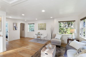Open layout with space to gather, dine, or unwind—set against a backdrop of treetops and sky.