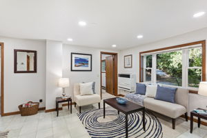 Tucked beneath the canopy, this space feels almost like a forest retreat. The large picture window connects you to the outside without sacrificing comfort inside.