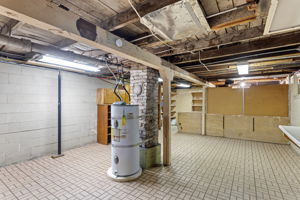 This expansive unfinished space includes a large workbench, pegboard wall, and built-in shelving—ideal for a home workshop, creative studio, or just everyday functionality. With around 1,000 sq ft total, there’s more than enough storage for two households.