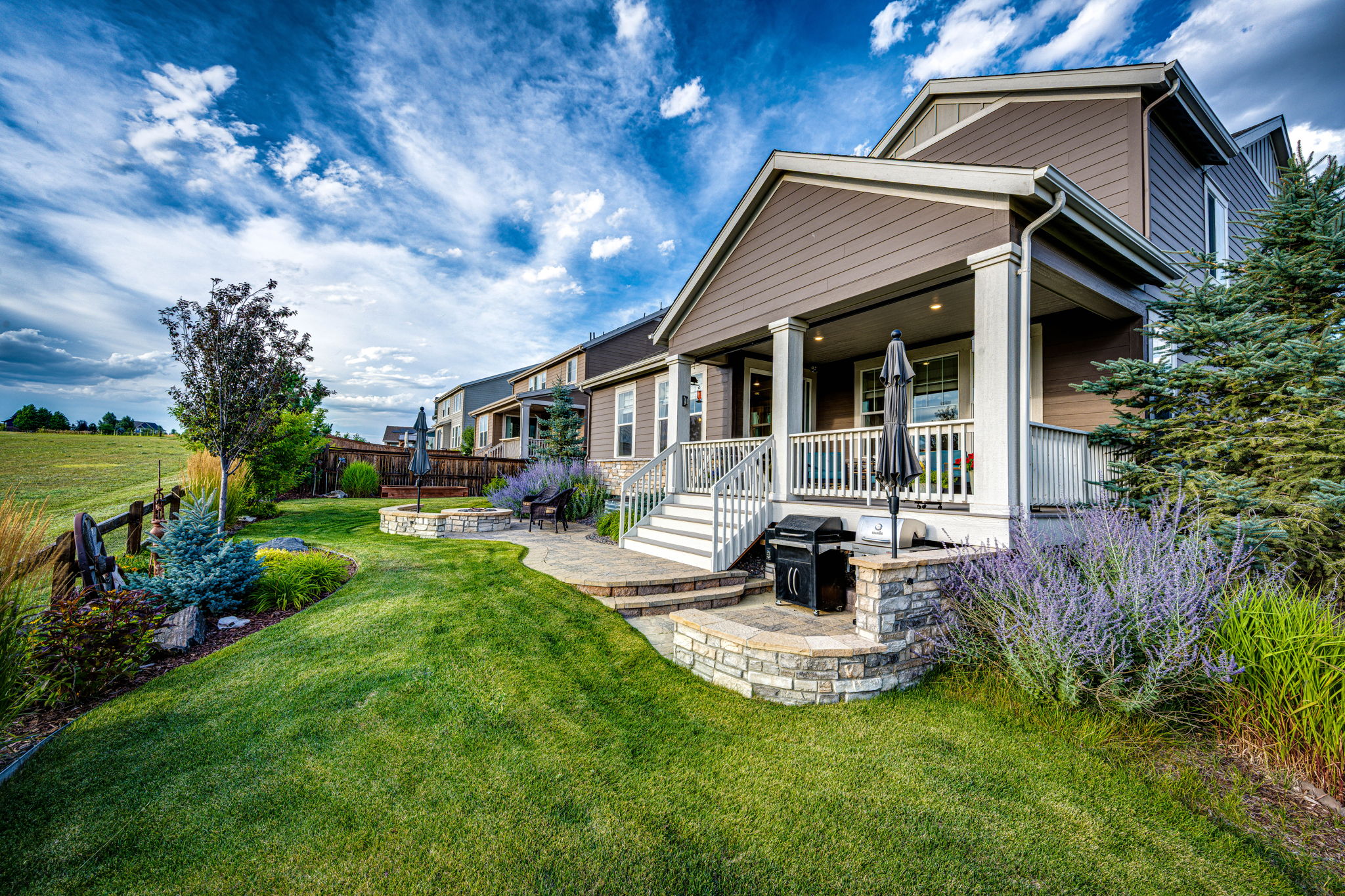 Fully landscaped backyard w/ built in umbrella stands