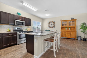 Brushed Nickel Hardware brings a nice updated finish to the rich-colored cabinets.