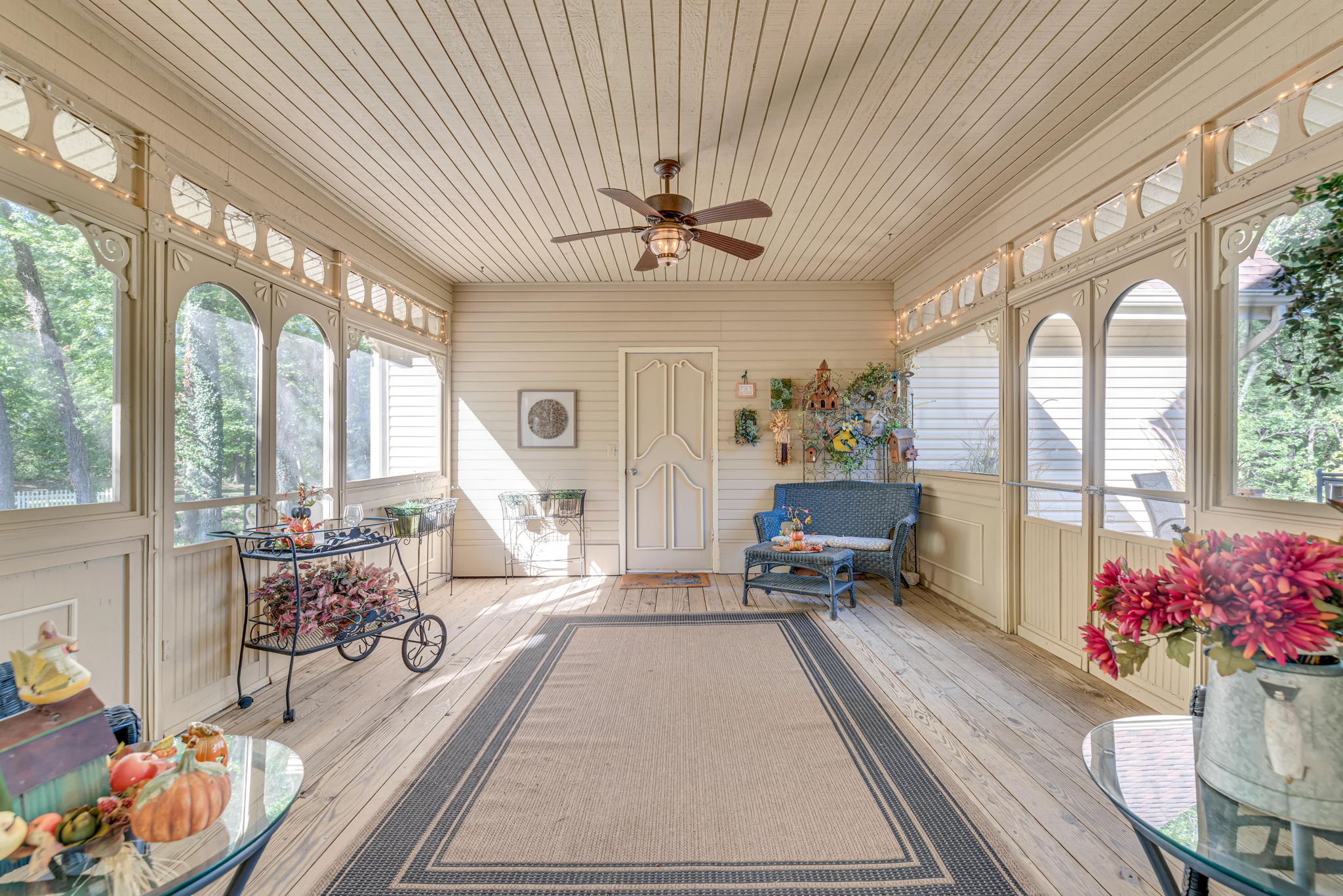 Breezeway to Garage just of kitchen Screened in with Ceiling fan and access to deck with views of the lake