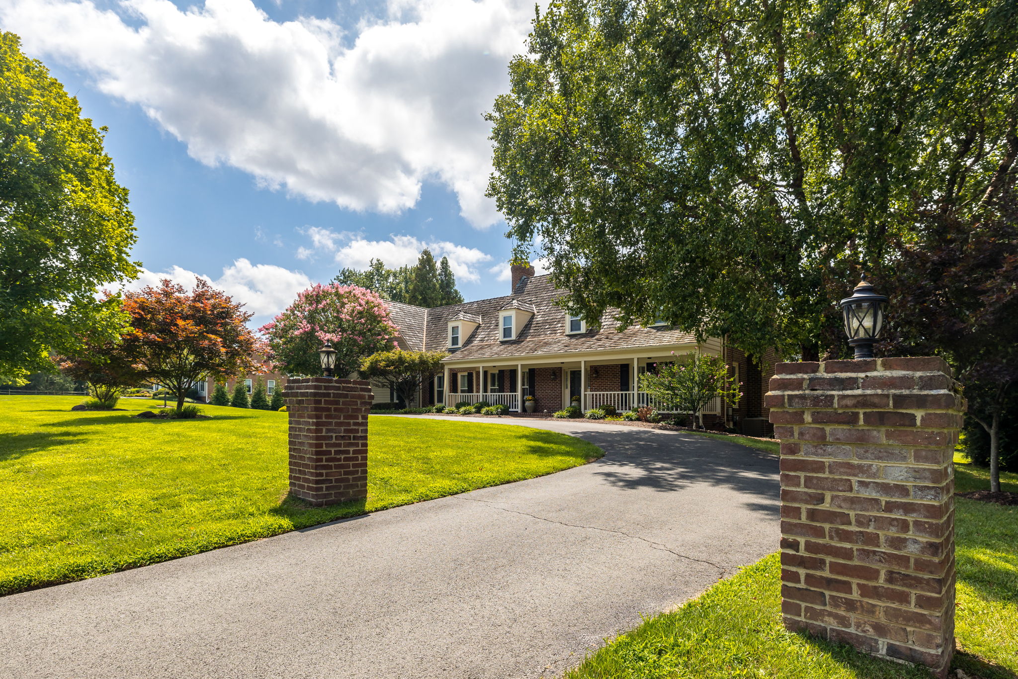Private Entry with Circular Driveway and Sport Court