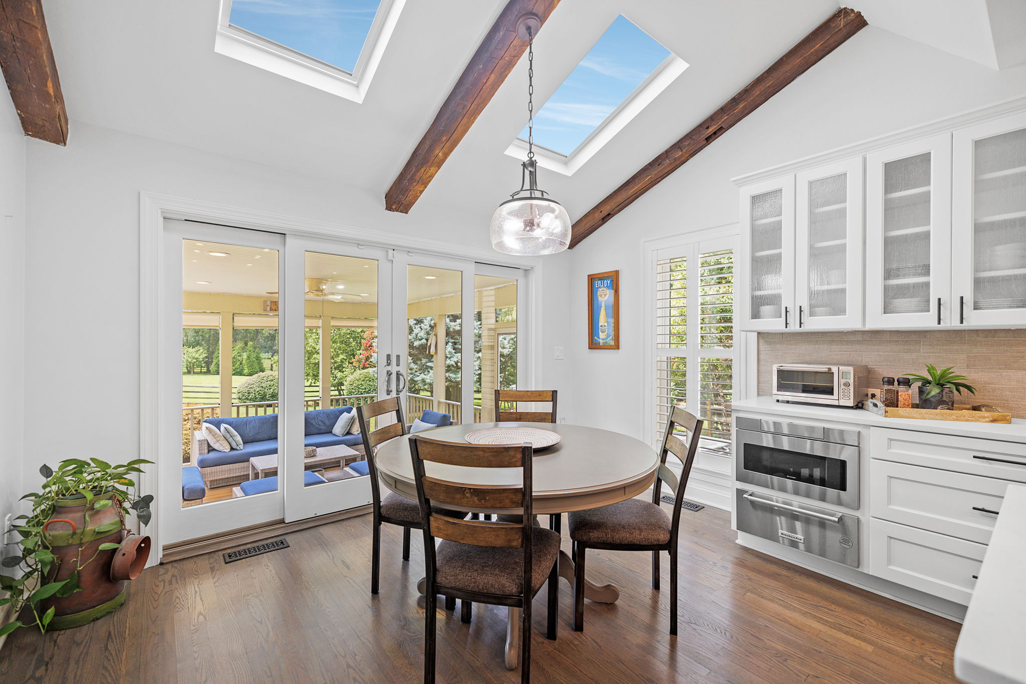 Breakfast Area with Skylights and Leading to Screened-in Patio