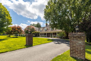 Private Entry with Circular Driveway and Sport Court