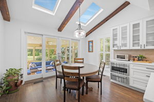 Breakfast Area with Skylights and Leading to Screened-in Patio