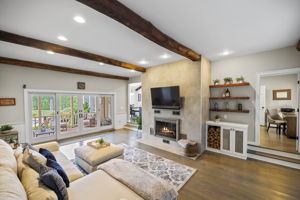 Family Room w/ Wood-burning Fireplace & access to Second Patio
