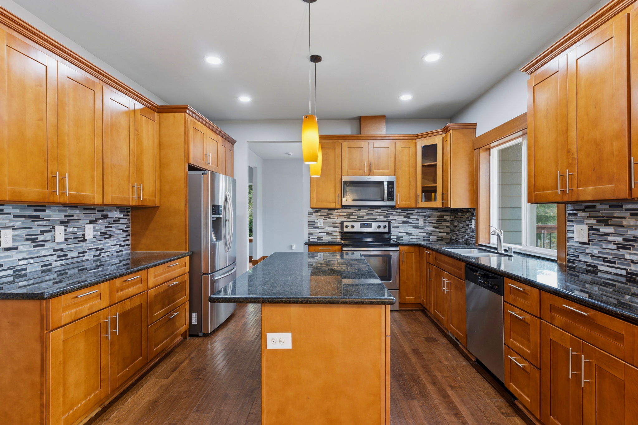 Main level kitchen, with quartz countertops and mahogany cabinetry