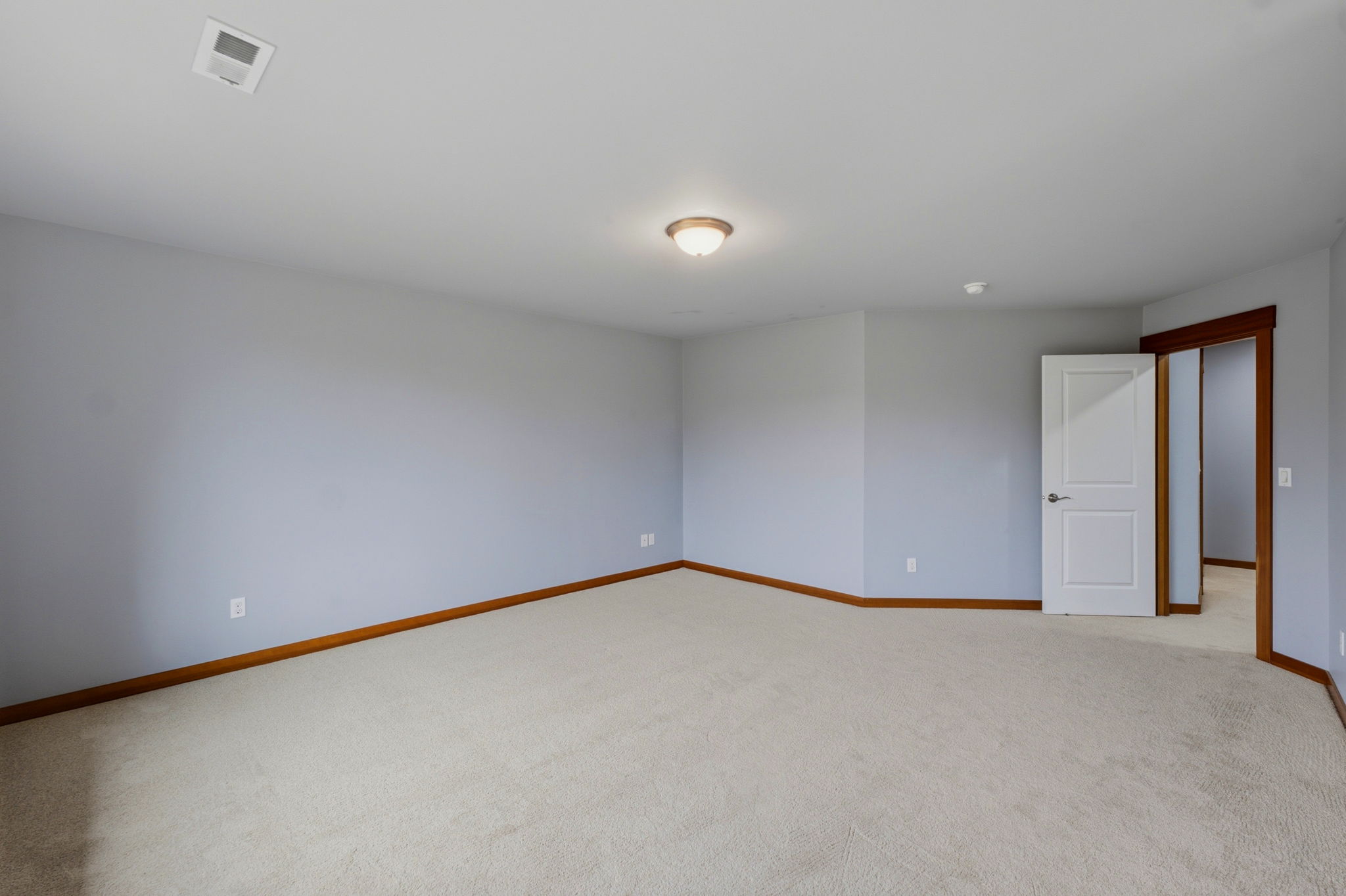Upstairs primary bedroom looking out to the hallway