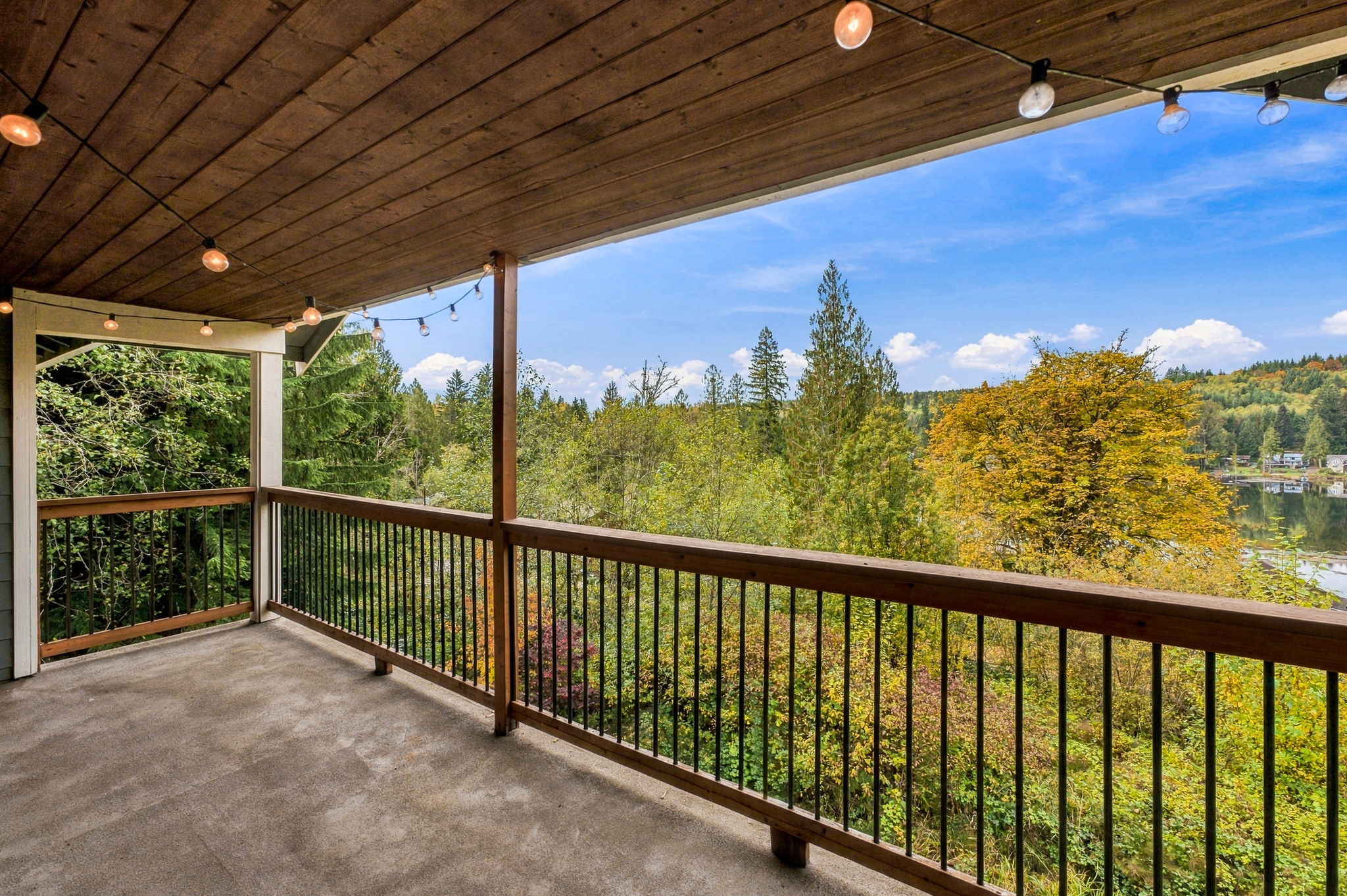 Upstairs primary bedroom deck overlooking the water and wooded views