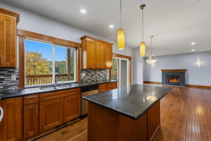 Main level kitchen with Main living room in the distance and water views out the window