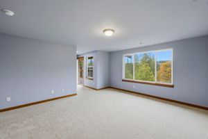 Upstairs primary bedroom passageway out to third level deck and continues to Primary bathroom and massive walk in closet