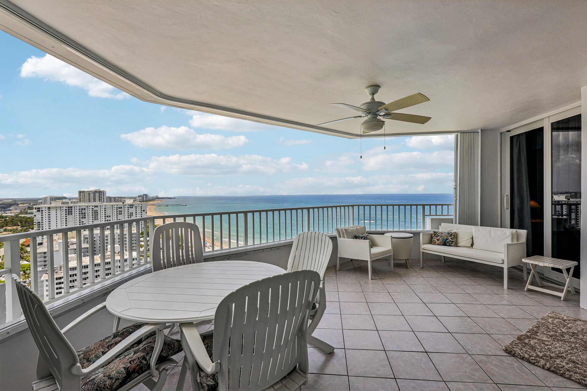 Large terrace with space for plenty of chairs and a dining table.