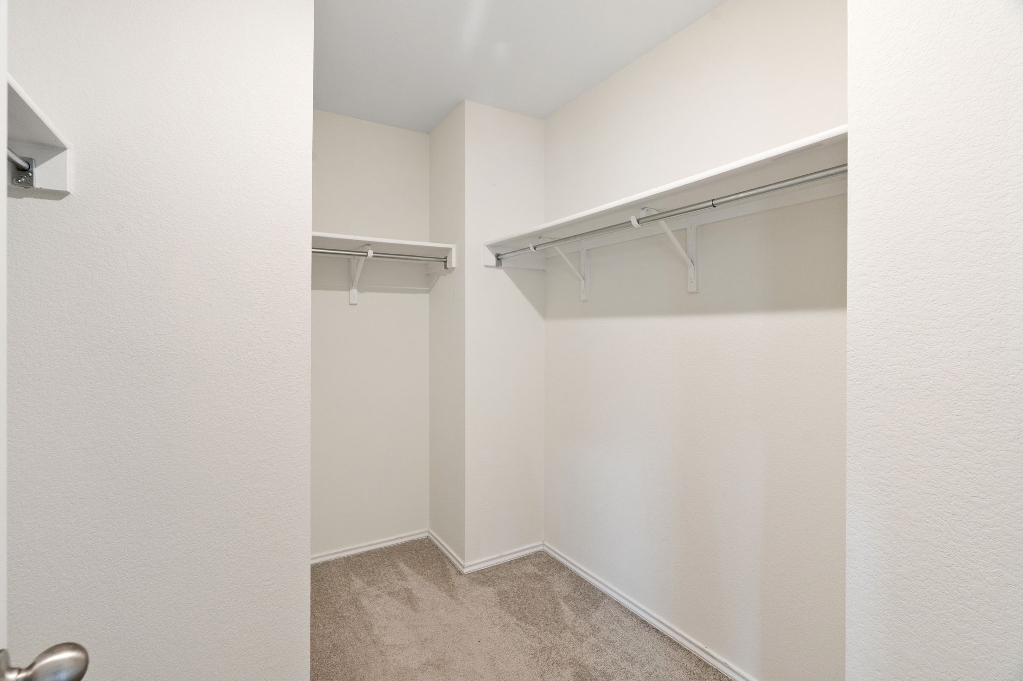 Primary bedroom walk-in closet