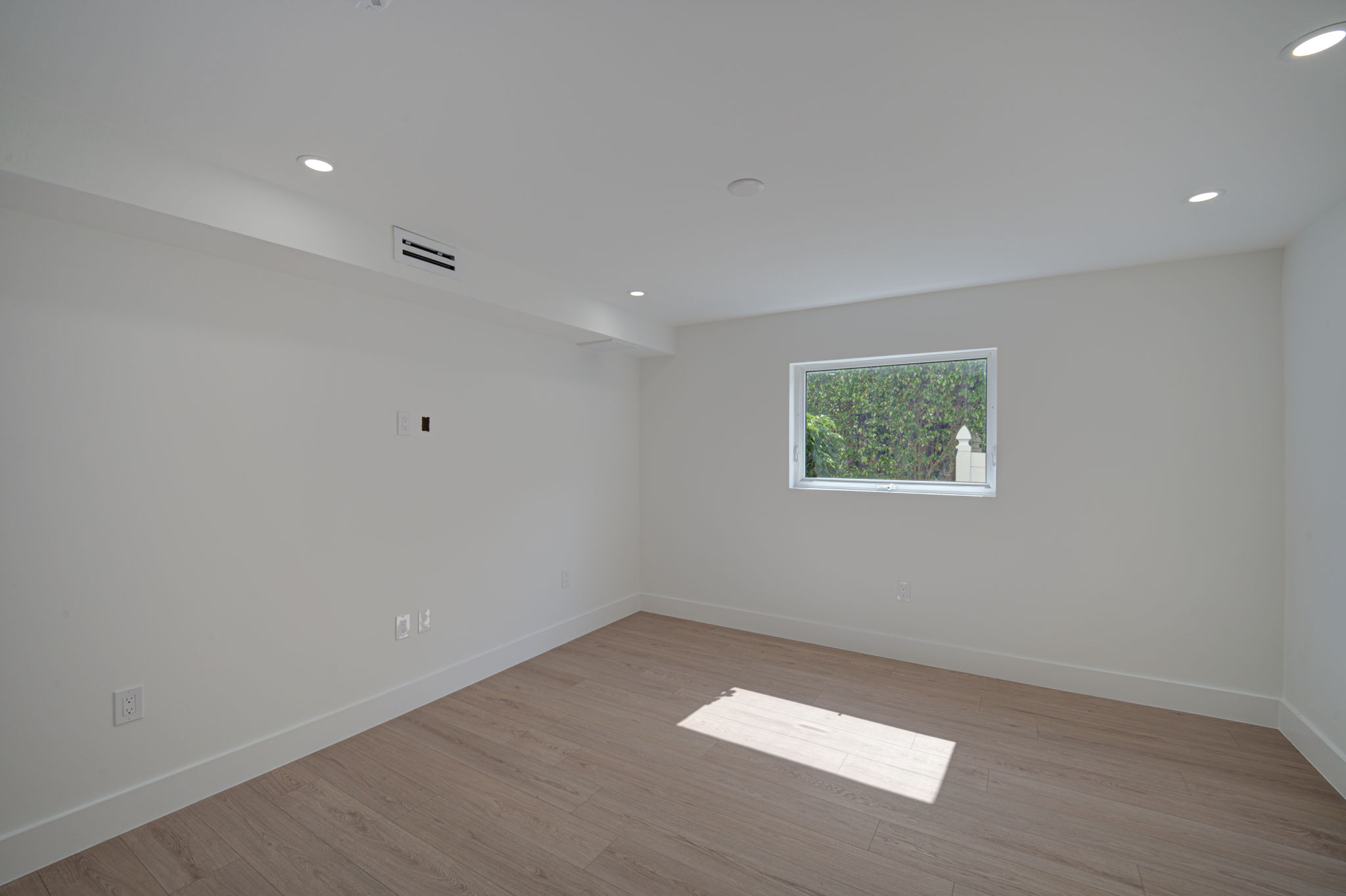 Additional bedroom angle emphasizing structural cross-ventilation from dual windows and modern interior design finishes.