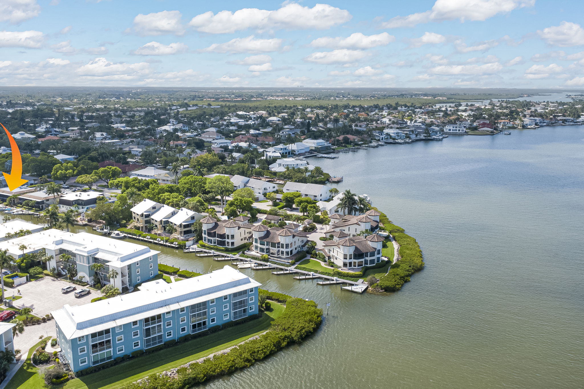 High-altitude drone photograph mapping the community's boating route to the wider bay and open Gulf waters.