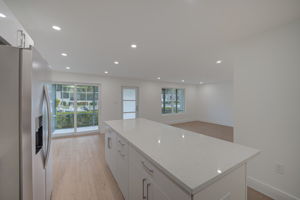 Reverse perspective from the kitchen looking outward, demonstrating the entertainer’s layout and direct line of sight to the waterfront.
