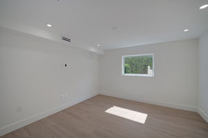 Additional bedroom angle emphasizing structural cross-ventilation from dual windows and modern interior design finishes.