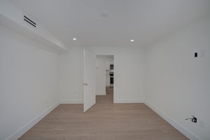 Interior hallway view detailing the consistent flow of luxury vinyl plank flooring and modern, flat-panel interior doors.
