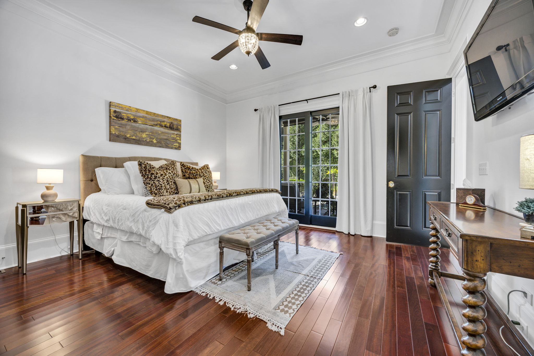 guest suite on main with sliding french doors to patio overlooking pool