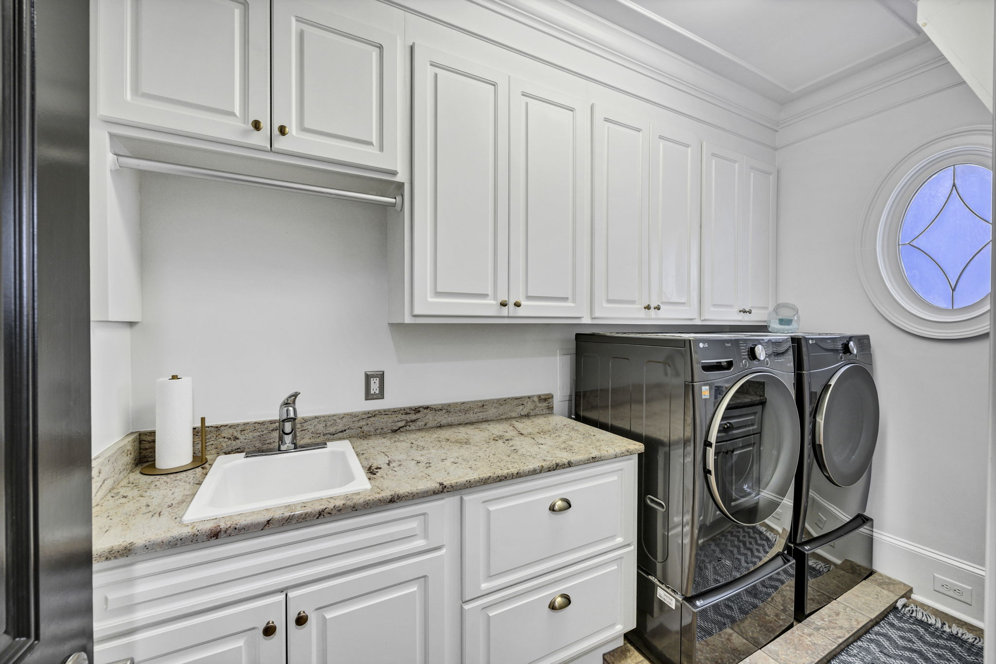 laundry room off kitchen, w utility sink & cabinetry - unpictured: shallow pantry, laundry chute