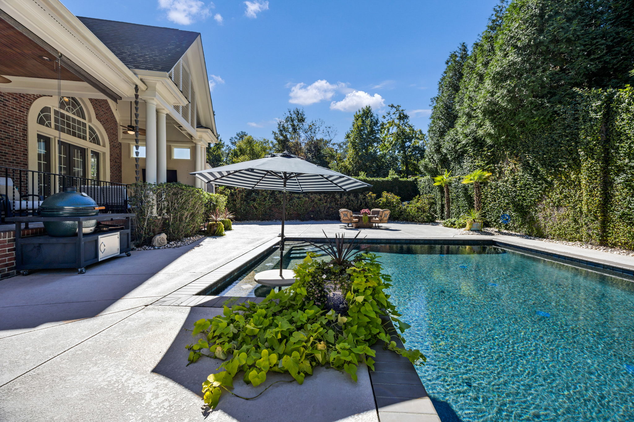 in-pool cocktail table w umbrella slot makes for the best parties