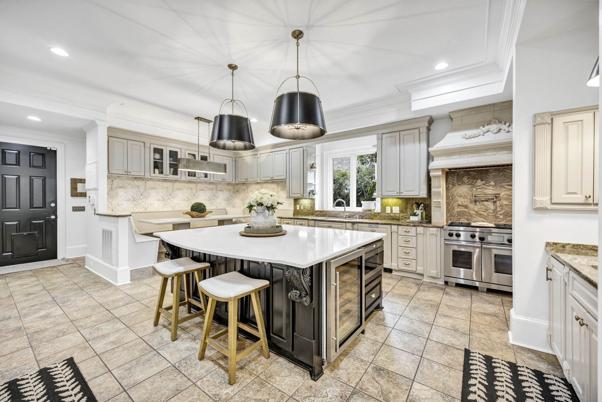 Oversized white quartz island is the focal point of this luxurious kitchen.