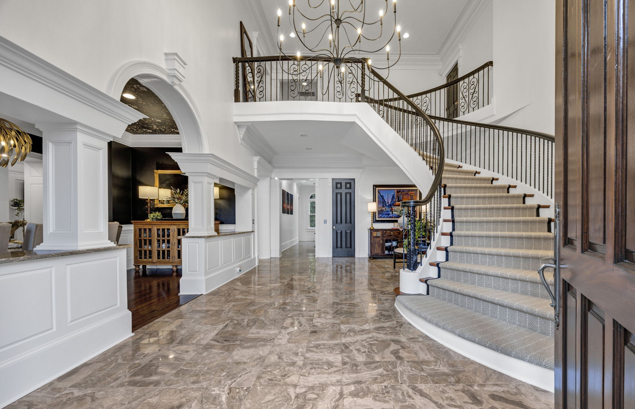 WOW-Factor 2-story marble foyer with sweeping staircase & 27-light chandelier
