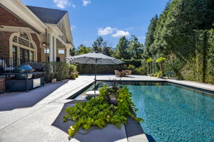in-pool cocktail table w umbrella slot makes for the best parties