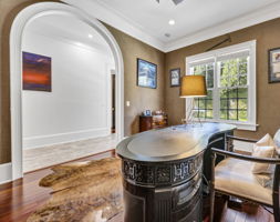 study with beautiful arched entrance; windows overlooking pool; textured walls