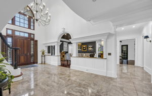 Marble Foyer with dining room and 1 of 2 corridors beyond