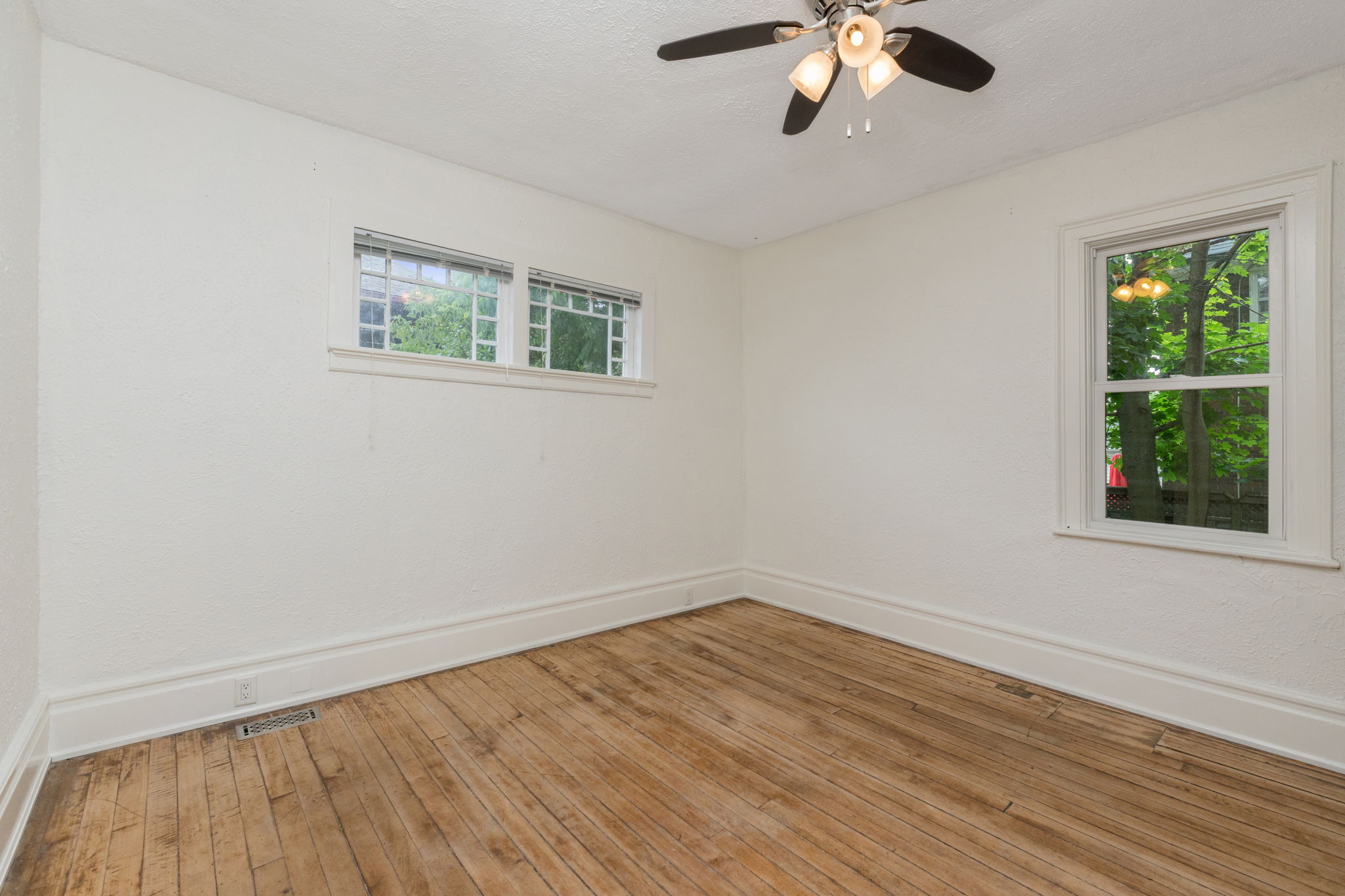 Bedroom with large closet and reclaimed hardwood