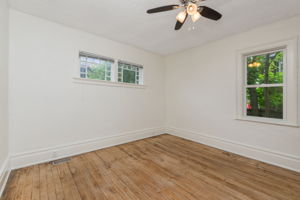 Bedroom with large closet and reclaimed hardwood