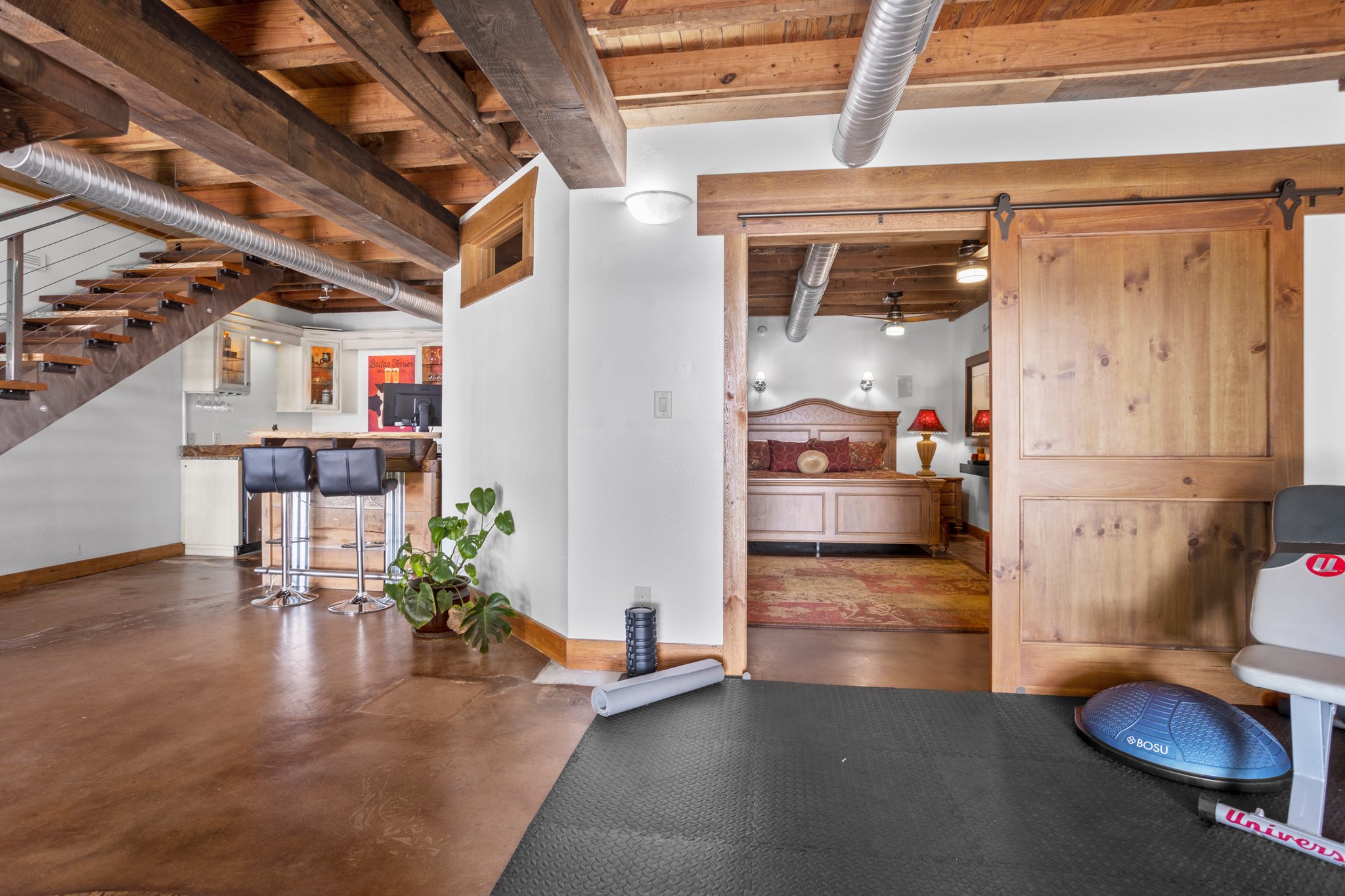 Barn door slides to reveal primary bedroom with a view to the lake!