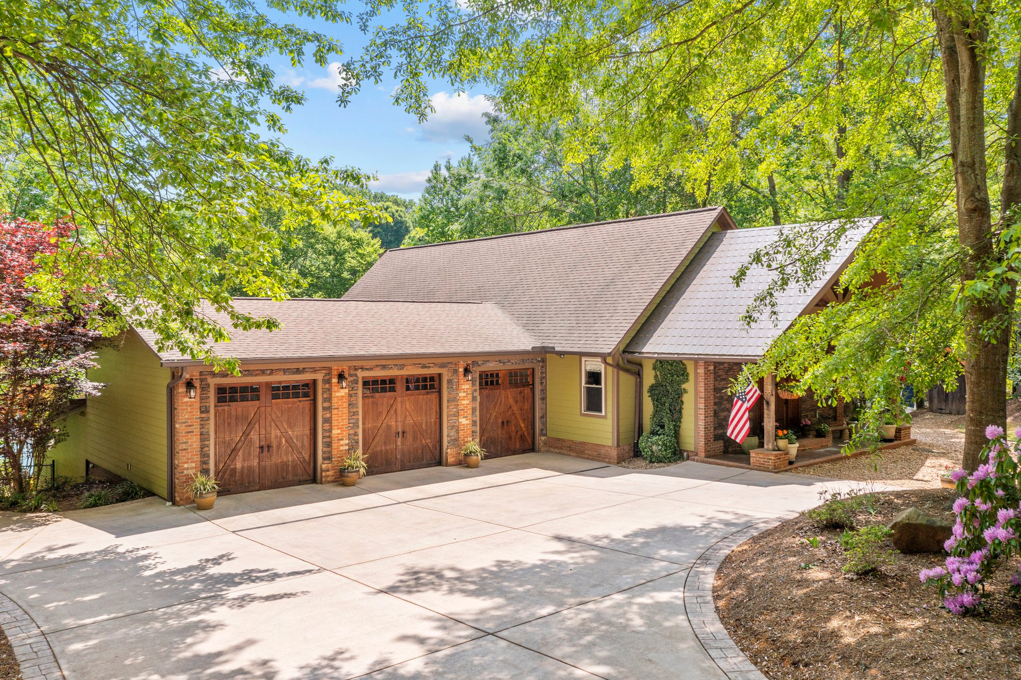 Three bay garage with sweeping drive.