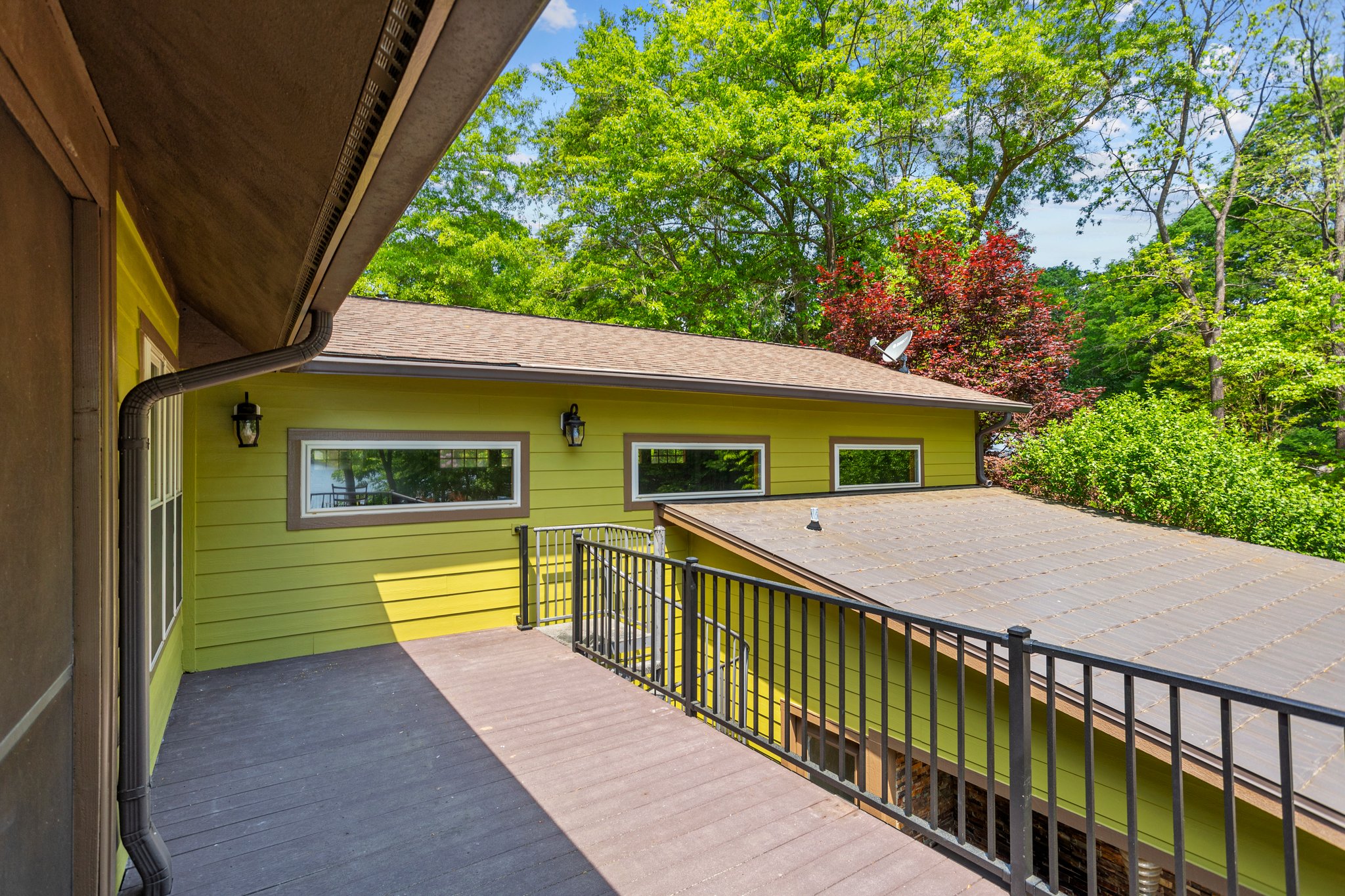 Clerestory windows which flood light into garage workspace. Roof over guest quarters has pressed metal tiles for architectural detail.