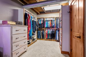 Open closet continues around corner.