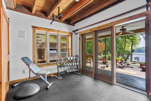 Flex space currently used as gym.  Wheel your bike out to the patio -- just like the HGTV fitness videos!