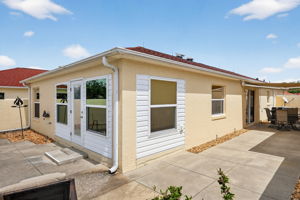 Partial Rear Patio with Side Patio and Remote-Controlled Awning