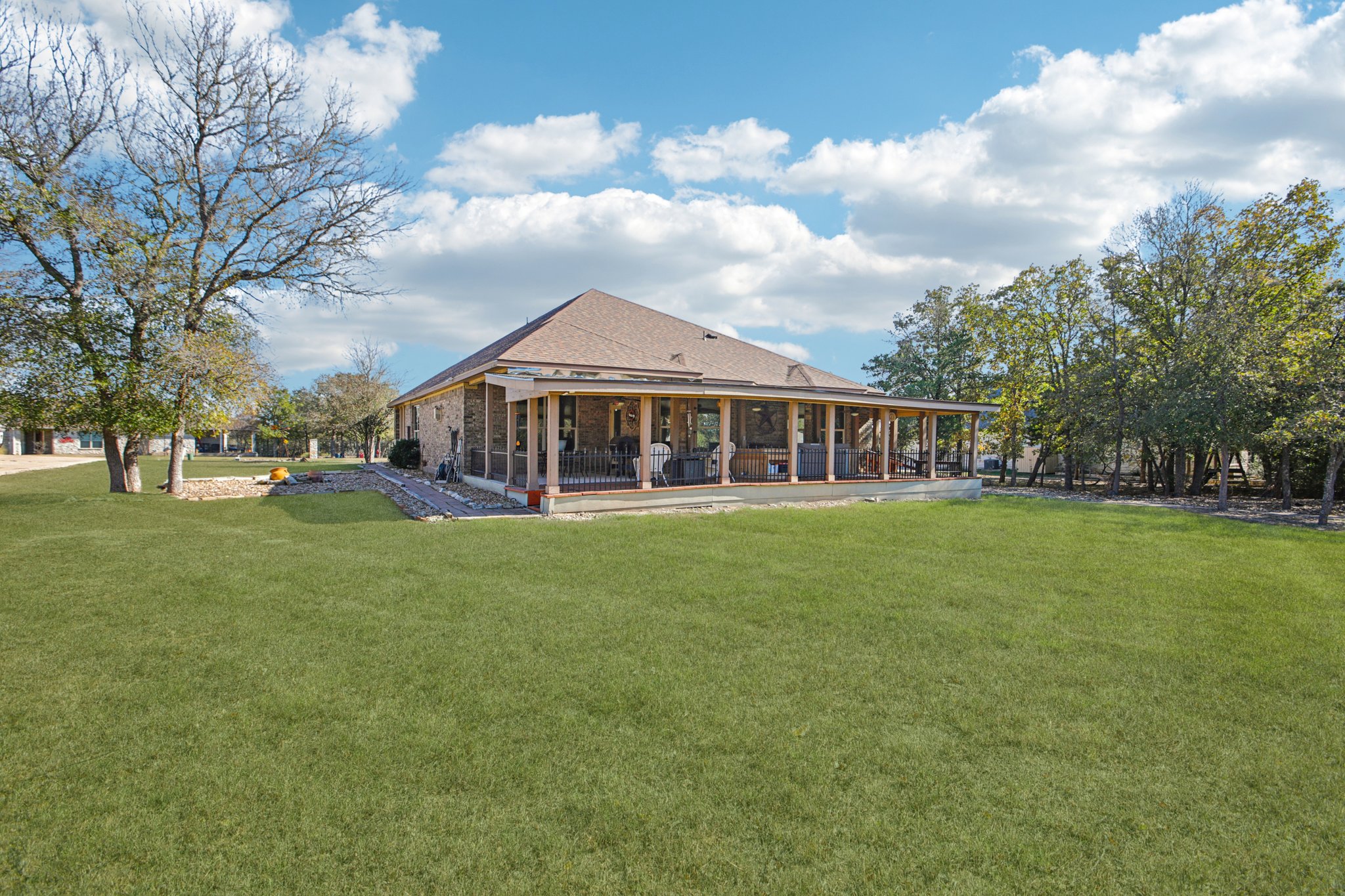 Spacious backyard and covered porch for entertainment.jpg