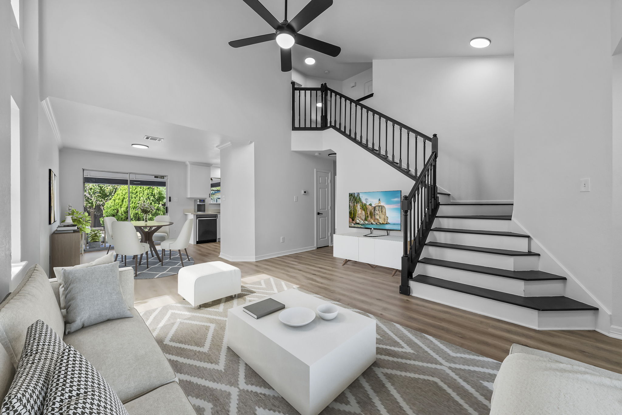 Virtually staged. Open and airy floor plan, soaring ceilings, grand staircase.