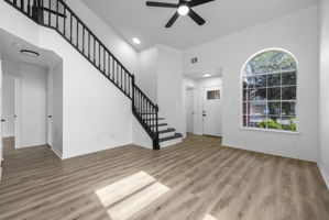 The door under the steps leads to the primary bedroom on the main level. The door to the left of the front door is to the laundry room and garage.