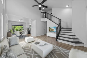 Virtually staged. Open and airy floor plan, soaring ceilings, grand staircase.