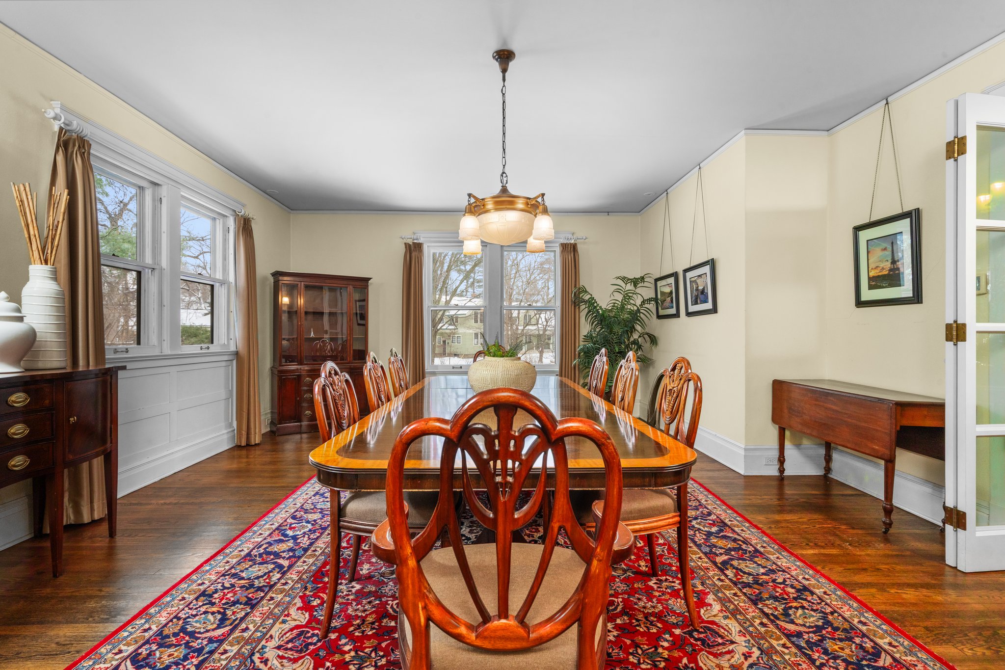 Formal Dining Room with wood floors and Rejuvenation Chandelier